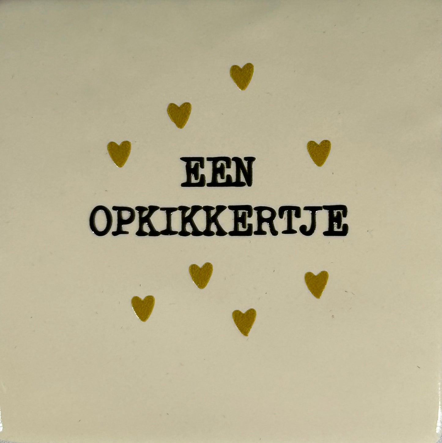 Quote tegeltje 'een opkikkertje' creme/zwart