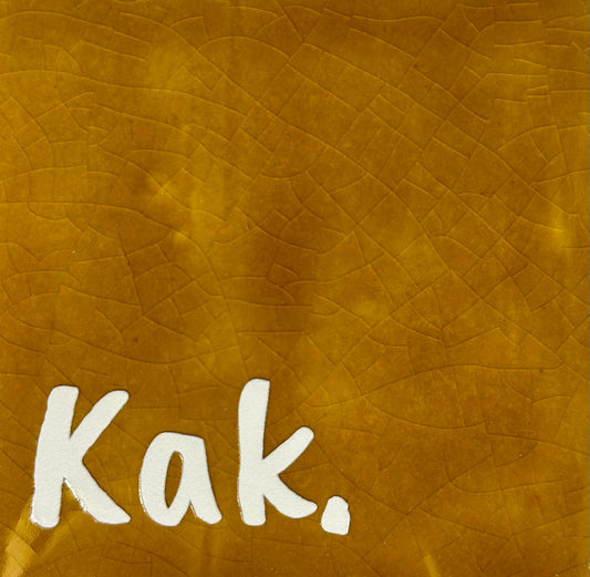 Quote tegeltje 'kak' oker/creme
