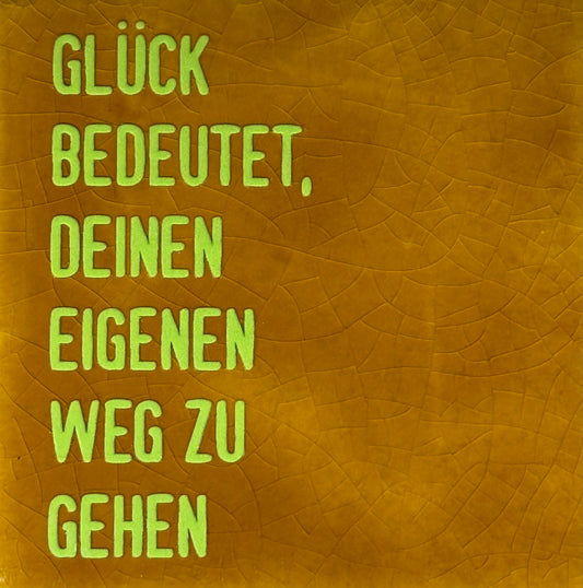 Quote tegeltje 'glück bedeutet...' oker/lime