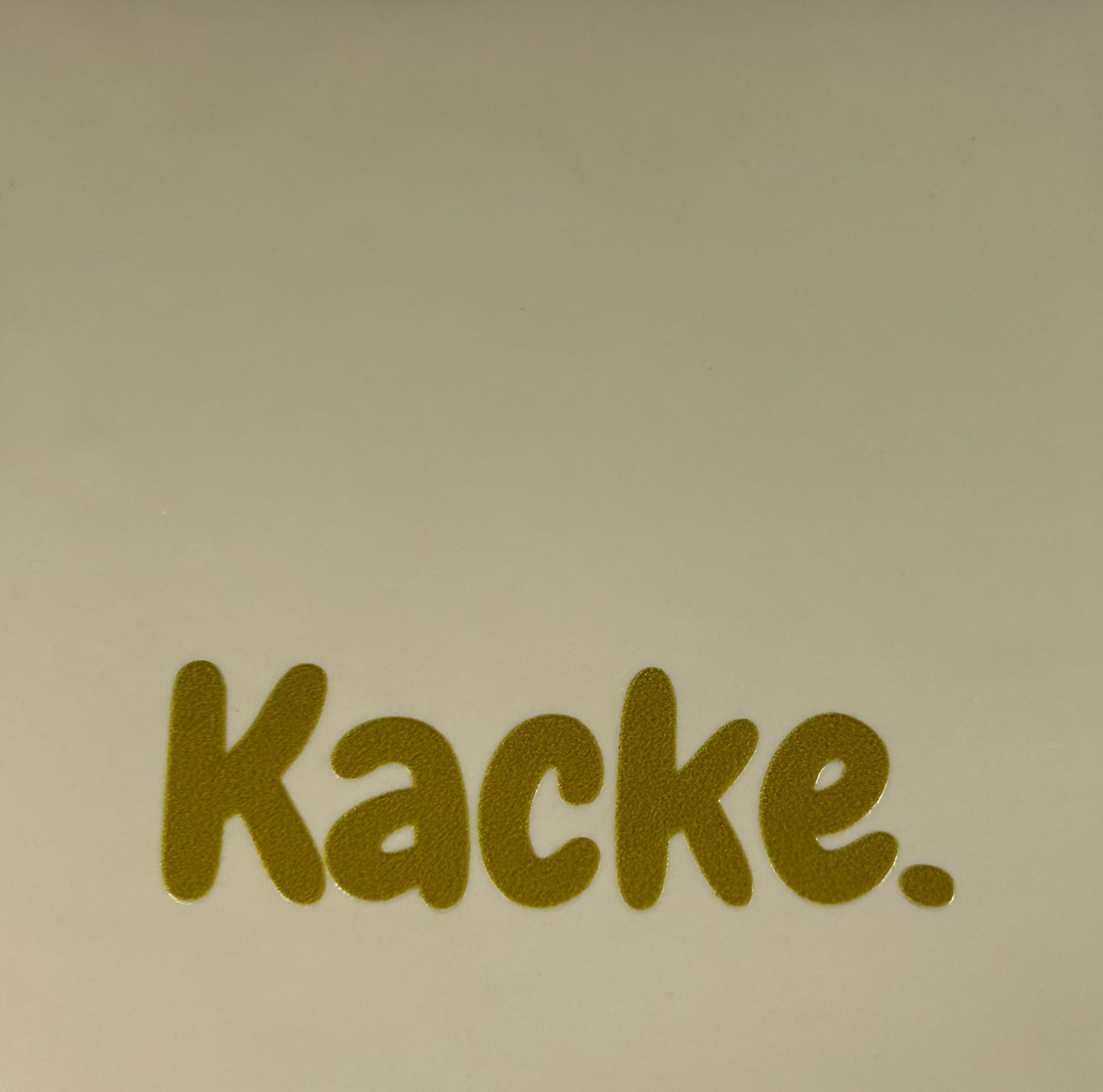 Quote tegeltje 'kacke' creme/goud